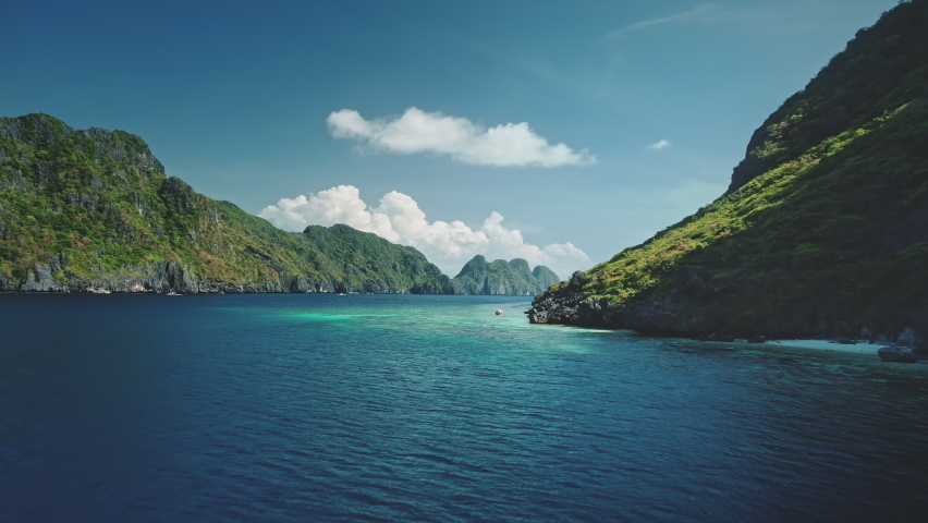Timelapse seascape at green mountain island aerial view. Serene and tranquil water of ocean bay with greenery hilly islets scenery. Amazing summer vacation at cruise boat around Philippine archipelago Royalty-Free Stock Footage #1061815525