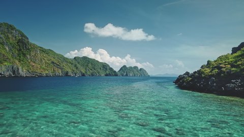 Timelapse seascape at green mountain island aerial view. Serene and tranquil water of ocean bay with greenery hilly islets scenery. Amazing summer vacation at cruise boat around Philippine archipelago
