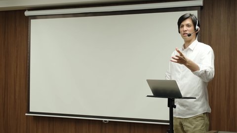 young asian businessman giving a presentation in a conference room