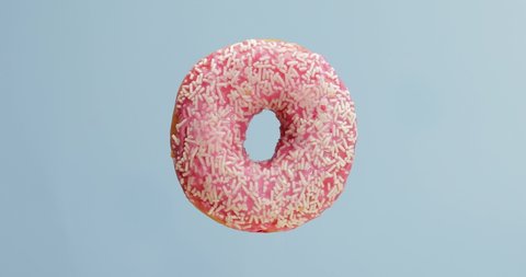 Tasty rotating donut on color background