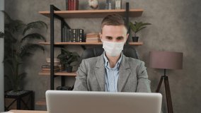 Man in face mask office workplace. Remote chatting colleague internet online meeting conference webinar. Distance work webcam. Coronavirus health care 4k - Powered by Shutterstock - Get 15% off with code: PIKWIZARD15