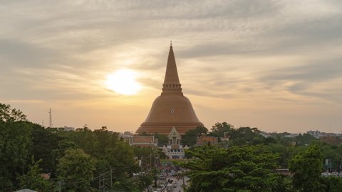 Time lapse of aerial view of Phra Pathom Chedi stupa temple in Nakhon Pathom near Bangkok City, Thailand. Tourist attraction. Thai landmark architecture. Golden pagoda at sunset.
