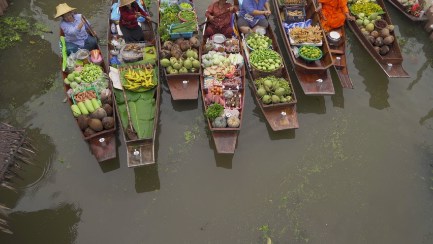 Damnoen Saduak Floating Market or Amphawa. Local people sell fruits, traditional food on boats in canal, Ratchaburi District, Thailand. Famous Asian tourist attraction.