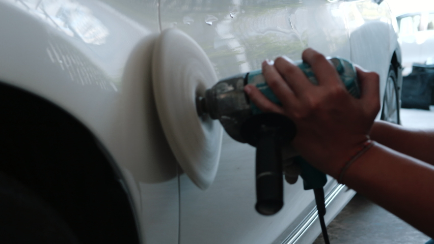 White car body polishing with polisher tool in auto service. Waxing car after car wash. Car body work - 4K | Shutterstock HD Video #1061828788