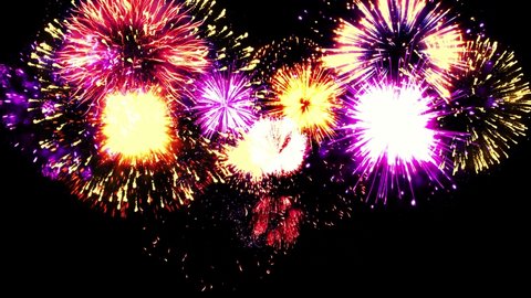  Colorful holiday fireworks background. 4K abstract blur of real golden shining fireworks with bokeh lights in the night sky. glowing fireworks show. New year's eve real fireworks celebration.