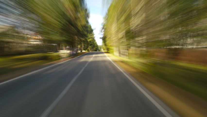 4K Point of View Hyperlapse Time-lapse of Car Driving Through Small Suburbia Trees Stretch on Both Sides High Speed On The Open Road Fast Car Hyperlapse Road Trip Travel Concept Sort of Dashcam POV.