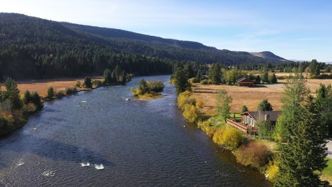 Aerial Madison River Montana summer homes mountain pt 1 4K. Beautiful mountain river in Teton and Yellowstone areas of Montana and Wyoming. Recreation for rafting, world class fishing.