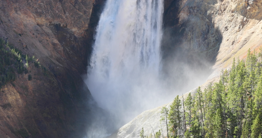 Yellowstone lower falls base and river in grand canyon mist 4K. Geyser Yellowstone in Wyoming, Montana and Idaho, USA. Geothermal geological environment ecosystem landscape. Biology geography and ecol