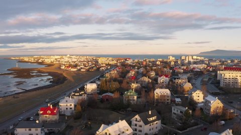 Drone flying over Beautiful Houses By The Coast In Reykjavik Iceland - aerial shot