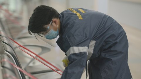 Janitor Disinfecting Public Chairs To Avoid The Spread Of Coronavirus Inside The Hospital