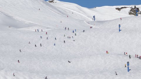 Panorama of skiers on ski slopes near Obertauern town, Salzburger Land of Austria.