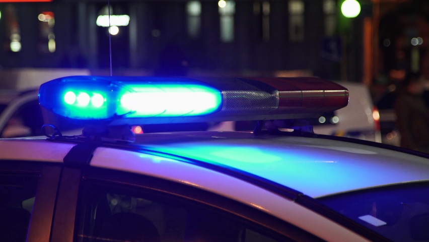 Police cars with flashing lights in the city center. Red police lights. Close-up. Blurred background. Flashing police lights. Royalty-Free Stock Footage #1061846851