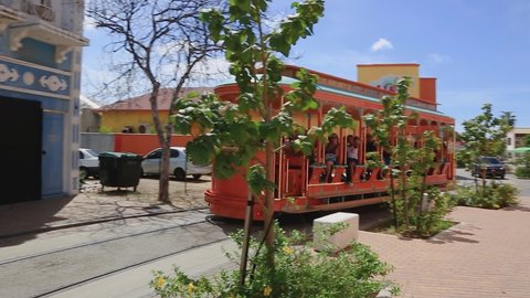 People ride the free streetcar around the shopping area in Oranjestad. 09.14.2019. Aruba. Oranjestad.
