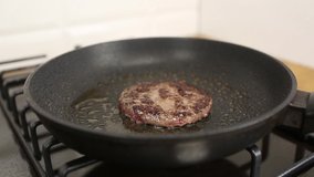 Ground beef meat patty frying on hot pan in close up 4k video clip.Minced pork being fried in closeup.Royalty free footage of cooking burgers.Natural healthy protein meal preparation for lunch meal