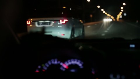High speed police pursuit on freeway at night. View from inside a police car