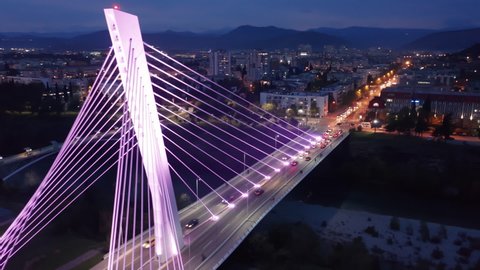 Illuminated cable-stayed bridge at night - modern architecture. Aerial view of Millennium in Podgorica Montenegro.