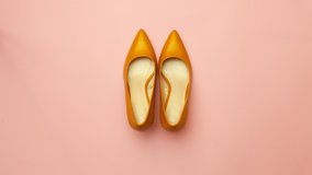 Yellow shoes with heels move on a pink background. Stop motion video. - Powered by Shutterstock - Get 15% off with code: PIKWIZARD15