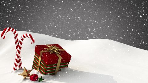 Digital animation of snow falling over christmas candy cane, gift box and bauble on snow against grey background. christmas festivity celebration tradition concept
