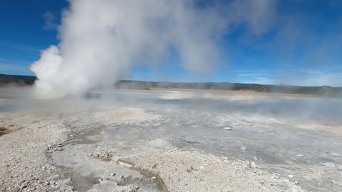 YELLOWSTONE, WYOMING - 22 SEPT 2020: Geyser eruption mud flats Yellowstone Park pov 4K. Geyser geology. Wyoming, Montana and Idaho, USA. Geothermal geological environment ecosystem landscape.