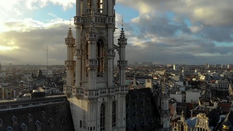 Aerial upward flying of Grand Place Brussels Town Hall on sunny and cloudy day in Brussels, Belgium.