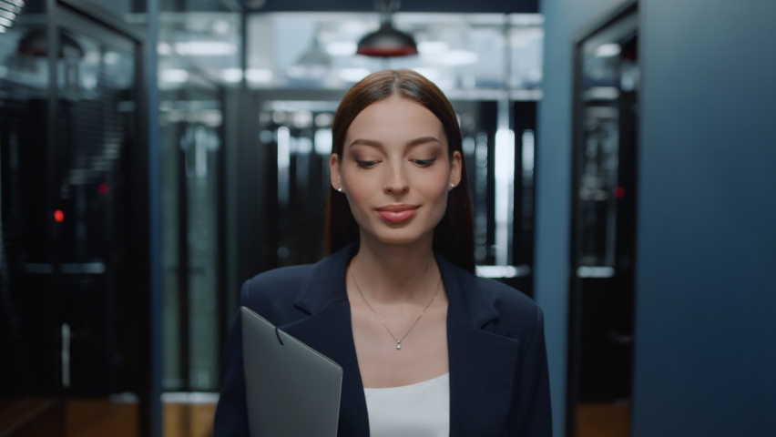 Closeup beautiful business woman walking in office corridor. Smiling businesswoman walking on meeting in office interior. Cheerful professional going on meetup in business center hallway | Shutterstock HD Video #1061868688