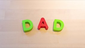 Dad text stop motion animation, jumping words for holiday or family concept. Social media footage. Family relationship creative footage. Descriptive seamless looping video for b-roll or title