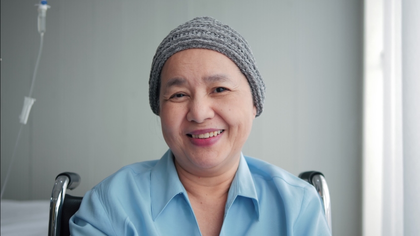 Portrait of smiling elderly Asian woman sitting on wheelchair with cancer wearing look at camera, elderly people healthcare concept. | Shutterstock HD Video #1061869489