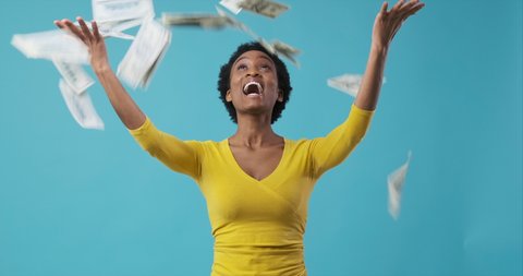 Excited woman throwing money and celebrating success