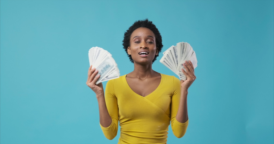 Happy woman dancing holding lots of money in hands | Shutterstock HD Video #1061869555