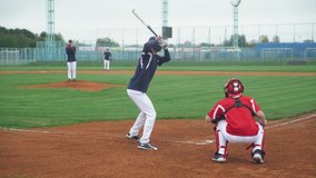 College sports, guys play baseball, the pitcher throws the ball towards the batter, batter successfully hits the fastball and run to base. - Powered by Shutterstock - Get 15% off with code: PIKWIZARD15