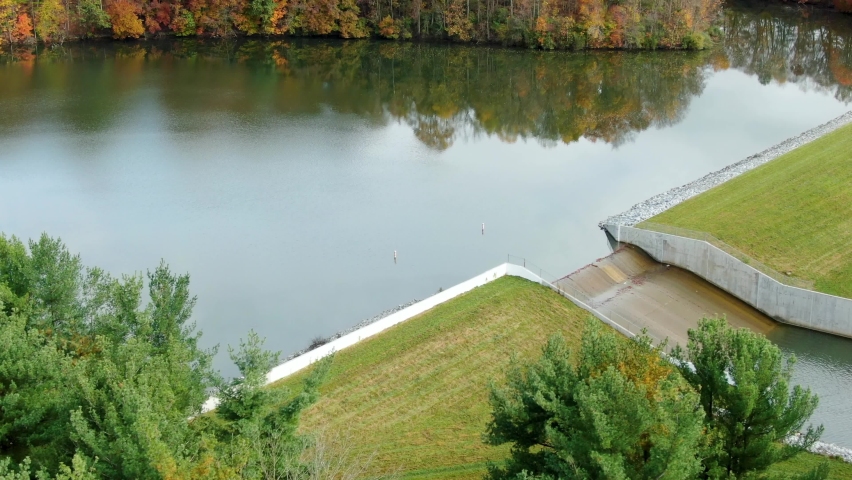 Speedwell Forge Dam and Lake. Aerial tilt-up reveals reflections of fall foliage during autumn in Lancaster County, PA, United States. USA.