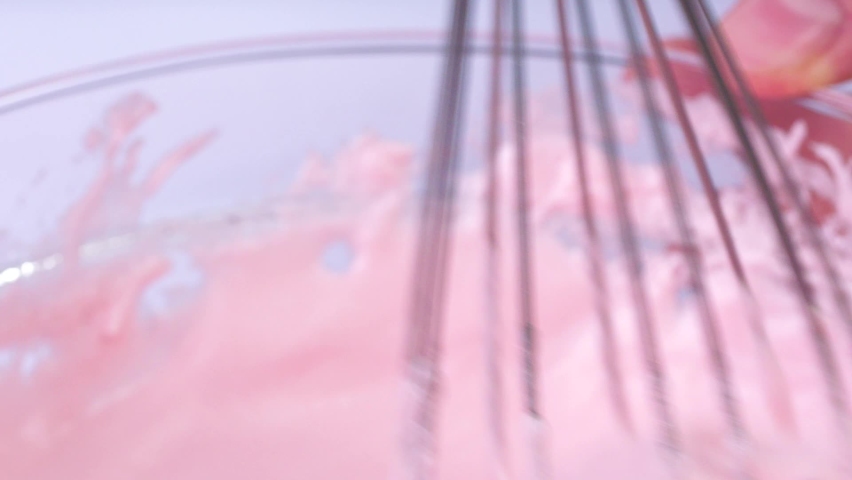 Pastry chef cooking cream. Pink cream whipping by the confectioner