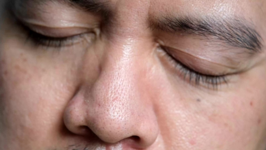 Asian men are rubbing their eyes due to dry eyes after working on a computer monitor or using a cell phone Royalty-Free Stock Footage #1061884645