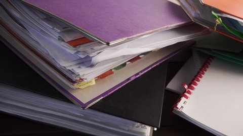 Paperwork documents in file binders close up sliding camera move stock footage