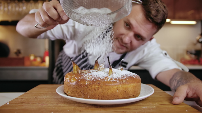 Close-up Man Chef at Restaurant Kitchen Serves Dish Focused Adding Final Ingredient by Hand. Cooking Cake Food at Modern Home Cuisine. Delicious Tasty Food. Preparing Appetizing Dessert Meal Slow mo | Shutterstock HD Video #1061888752