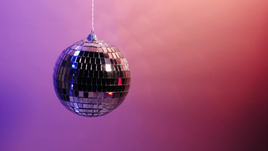 Disco ball spinning on neon purple background. 360 degree rotation. Zero gravity, levitation. 4k footage Royalty-Free Stock Footage #1061888974