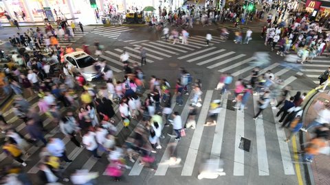 Time lapse of many people crossing the crosswalk in China city, at night