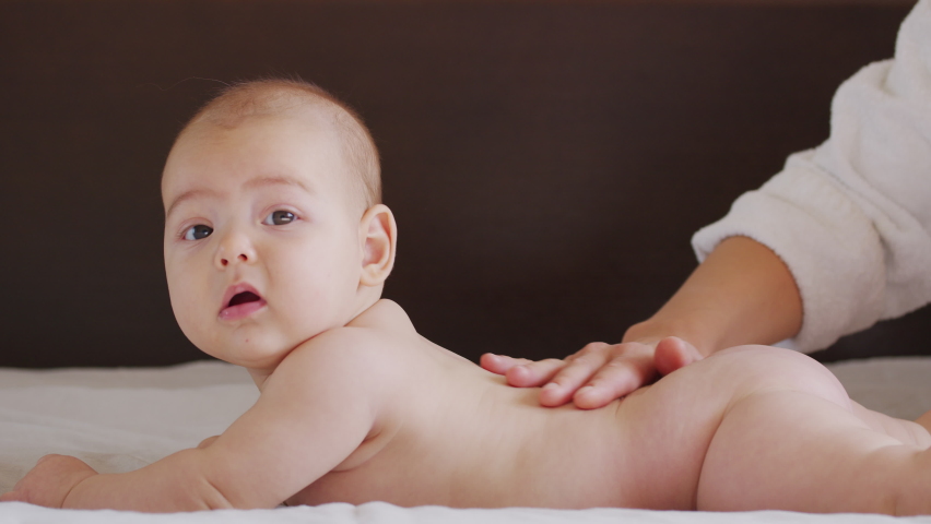 Mom Gives Back Massage To Her Little Child. Closeup. Royalty-Free Stock Footage #1061891602