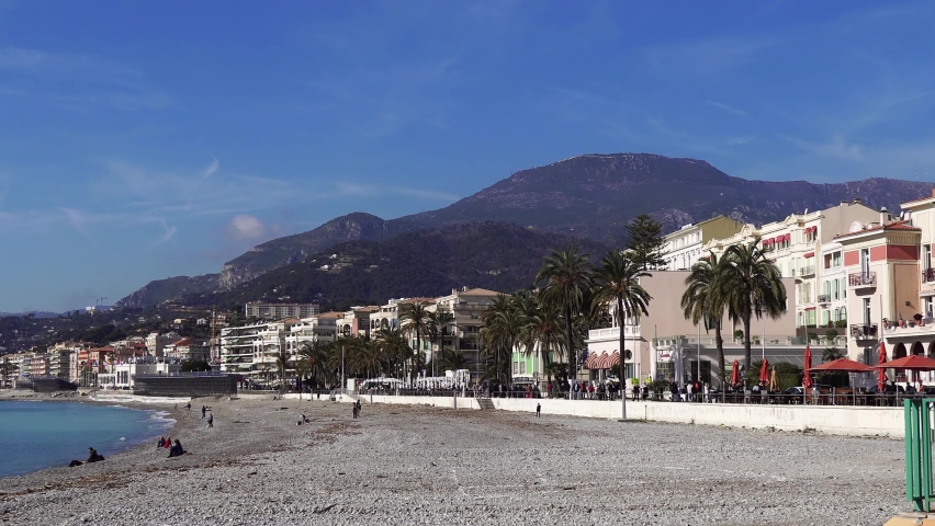 Holidaymakers are cheerful people on the French Riviera, with a beautiful view of the mountains, in the wonderful city of Menton.