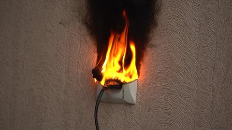 Electric socket fire. On fire electric wire plug Receptacle wall partition,Electric short circuit failure resulting in electricity wire burnt.