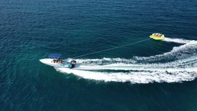 Aerial drone video of extreme powerboat donut watersports cruising in high speed in tropical emerald sea bay