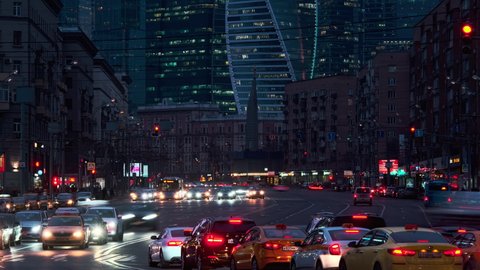 Timelapse of busy crossroad at modern european city. Modern City at Night. Cars, Lights, Contemporary Buildings in front of Moscow City. Cinematic View of beautiful town at Night.