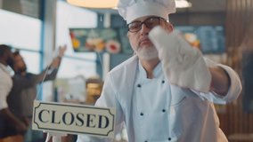 Chef cleaning window and turning open sign board on glass door in modern cafe. Restaurant staff preparing for opening washing and wiping furniture and dishes - Powered by Shutterstock - Get 15% off with code: PIKWIZARD15