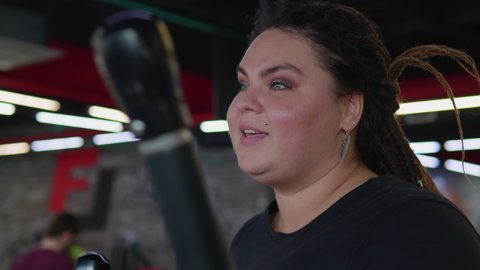 Overweight woman running on treadmill. Weight loss, body positive, sport concept. Filmed on RED 4K, 10 bit color.