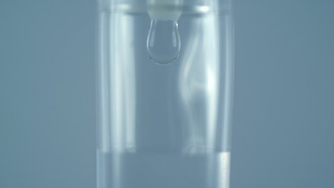 Macro close up of drops falling from saline liquid bag or IV bag in slow motion filmed with high speed camera 库存视频