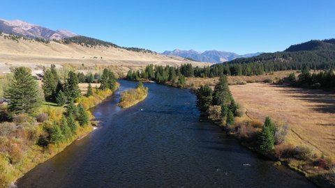 Madison River Wyoming autumn fall colors mountain view 4K. Beautiful mountain river in Teton and Yellowstone areas of Montana and Wyoming. Recreation for rafting, world class fishing.