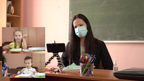 Virtual online meeting of a young teacher in a protective mask and little students. Video tutorial during quarantine. COVID-19. Counting fingers. Preschool education. Collage on screen.4k