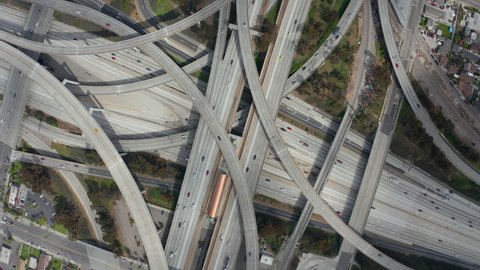 AERIAL: Spectacular Turning Overhead Shot of Judge Pregerson Highway showing multiple Roads, Bridges, Viaducts with little car traffic in Los Angeles, California on Beautiful Sunny Day 