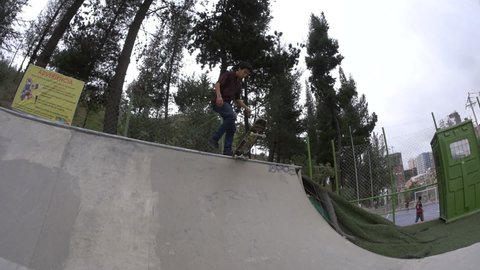 La Paz / Bolivia - November 23 2015: A Young Brown Man is Skating in a Park with a Half Pipe