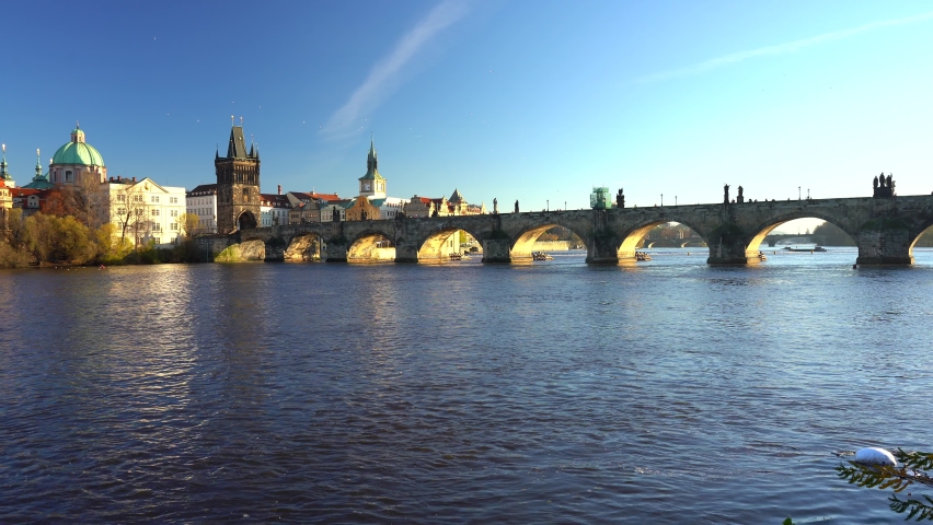 
static shot of the view of charles bridge and flowing river vltava in the center of prague at sunset the sky is blue in czech republic Royalty-Free Stock Footage #1061922796
